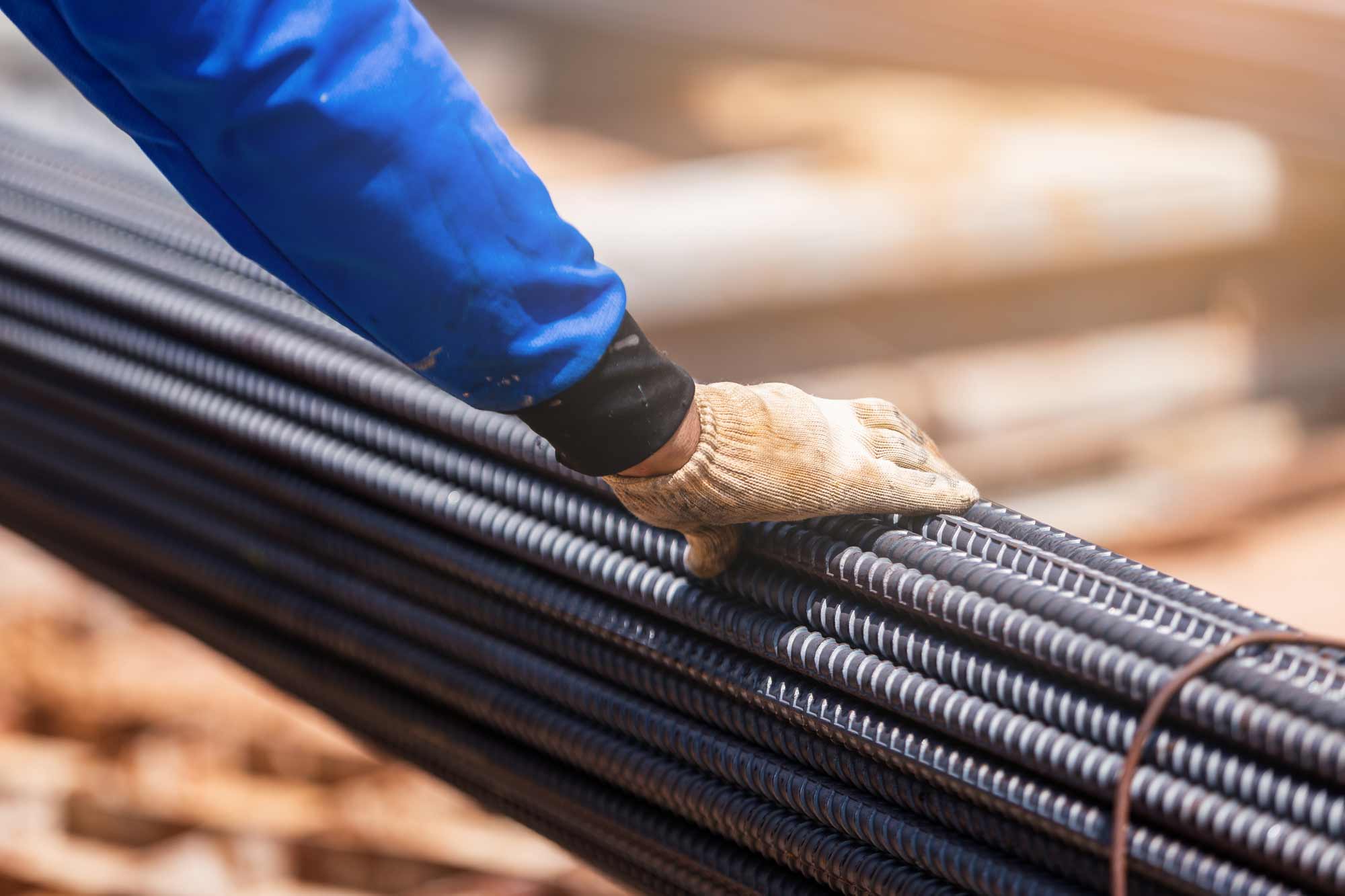 construction worker inspecting steel bars