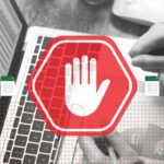 stop sign over a laptop with spreadsheet